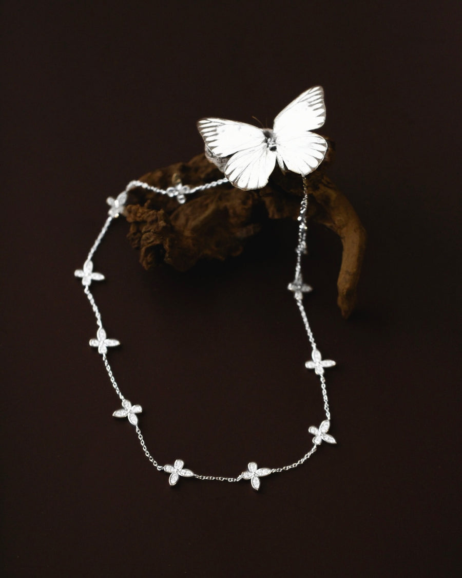 Silver butterfly necklace on a dark background